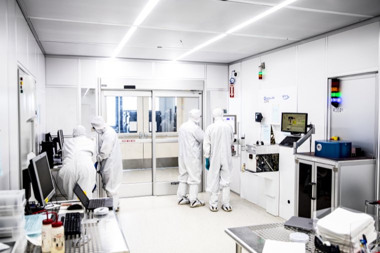 Researchers passing through the doors into the cleanroom