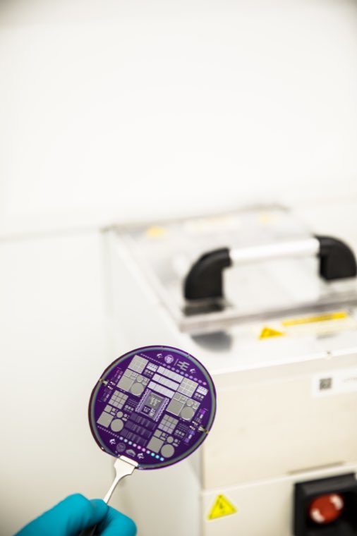A finished patterned wafer held in tweezers