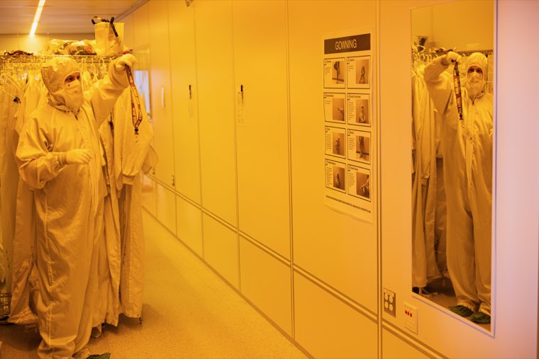 People putting on cleanroom suits in the gowning room