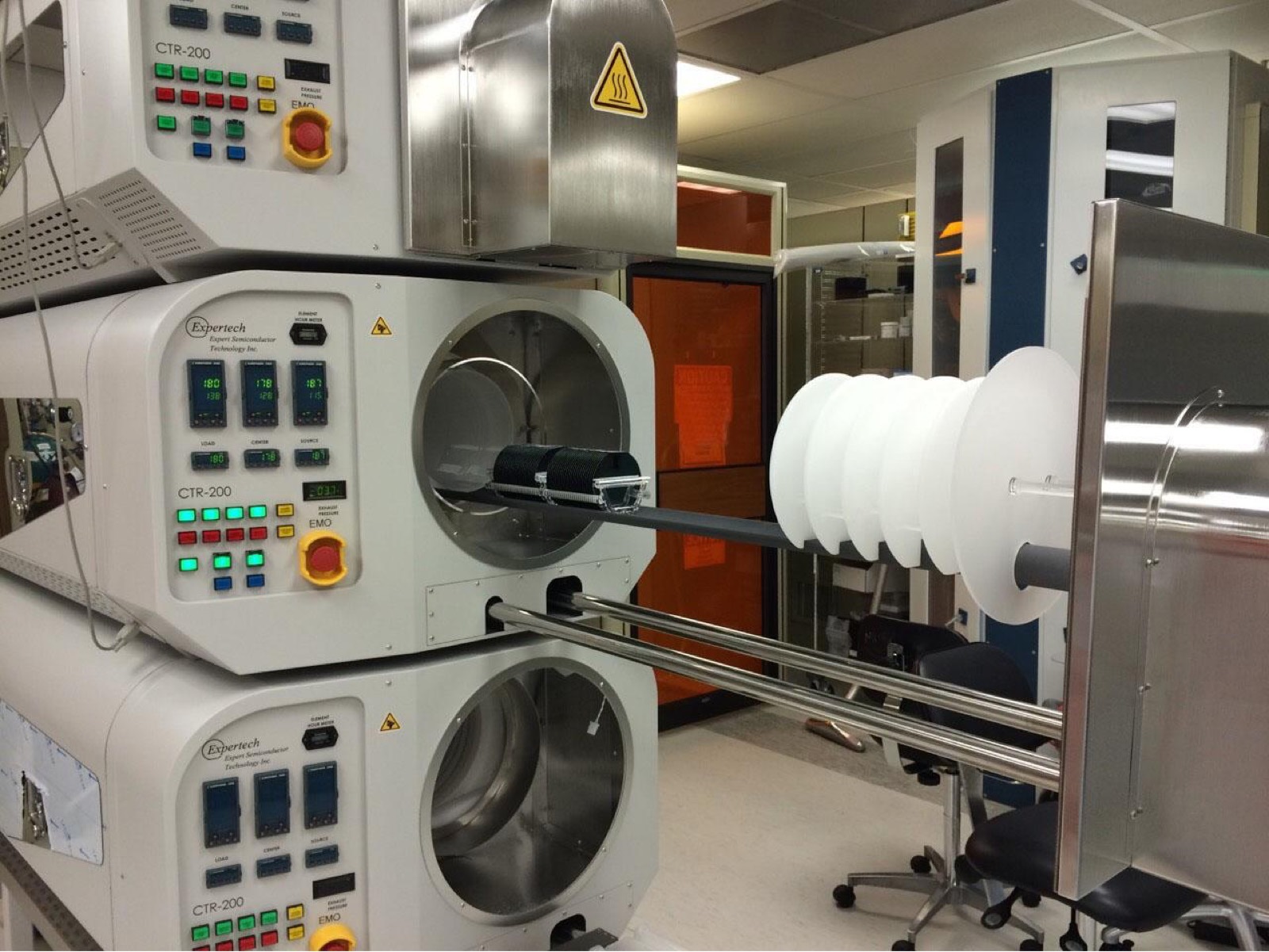 Diffusion furnaces in the cleanroom at the Washington Nanofabrication Facility, with silicon wafers loaded on the paddle